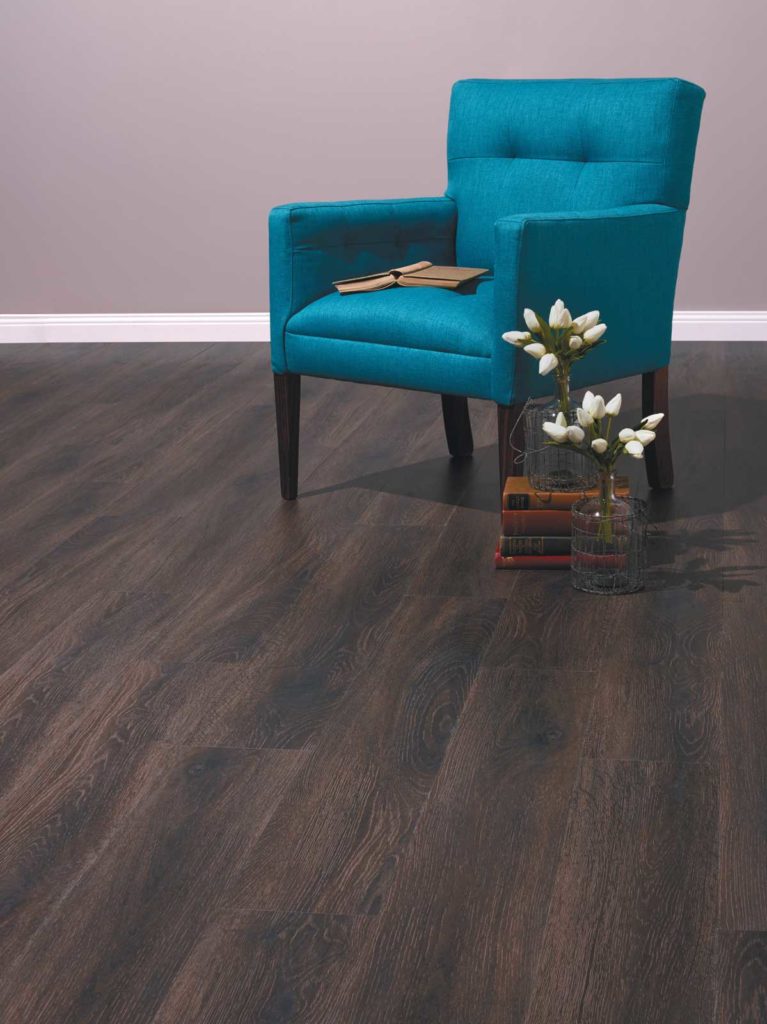 Luxury Vinyl Plank Smoked Oak Flooring in Burnt Husk Colour with Blue Chair